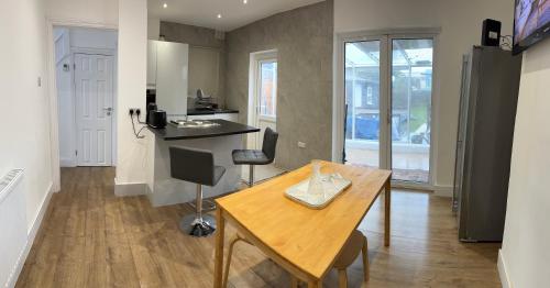 a kitchen with a wooden table and a counter top at stadium home in London