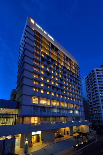 a tall building with lights on top of it at Naha Tokyu REI Hotel in Naha