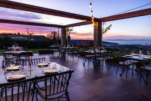 a restaurant with tables and chairs with a view at Štok - Rooms, Wine & Restaurant - Marezige, Koper in Koper