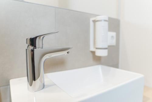 a bathroom sink with a chrome faucet at Summit of Saxony Resort Oberwiesenthal in Kurort Oberwiesenthal