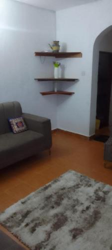a living room with a couch and a rug at Serena beach villas in Mombasa