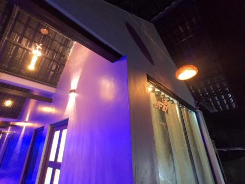 a building with purple lights on the side of it at JFZ Homestay in Honāvar