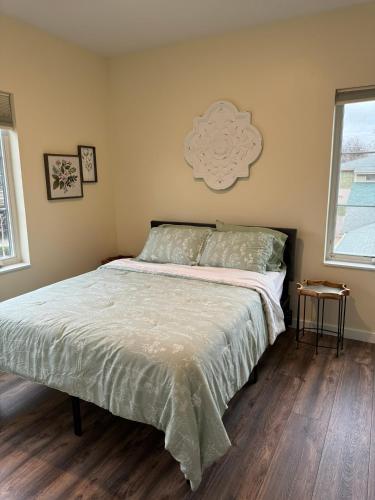 a bedroom with a bed with a white comforter at N Walnut Street in Bloomington
