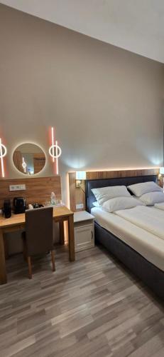a bedroom with a bed and a desk and a mirror at Elegance Studios in Vienna