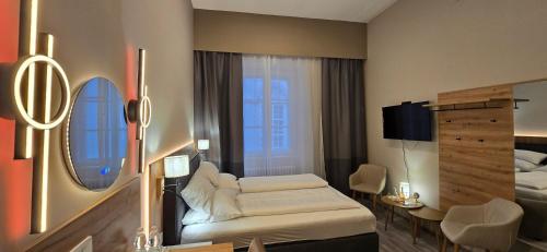 a hotel room with a bed and a mirror at Elegance Studios in Vienna