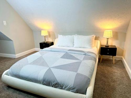 a bedroom with a large bed with two lamps at The House Hotels - Terrific W33rd in Cleveland