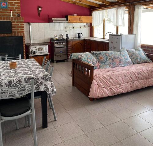 a kitchen with a bed and a table in a room at Moza in Trevelin