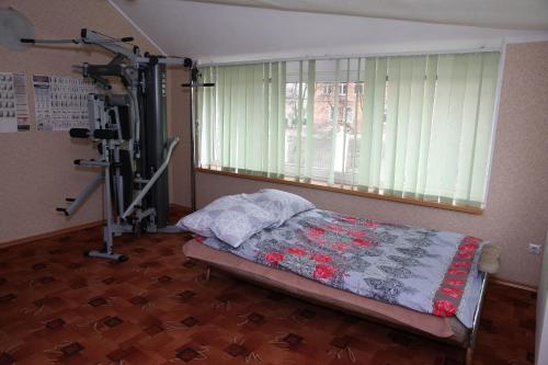 a bedroom with a bed and a gym equipment at Apartments na Krasnoy armii 42 in Baltiysk