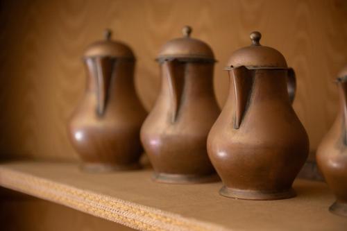 a group of brown vases sitting on a shelf at Dimora 'Medoro' in Colli al Volturno