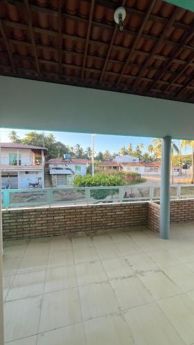 an empty patio with a view of a building at Casa Verde Japaratinga in Japaratinga