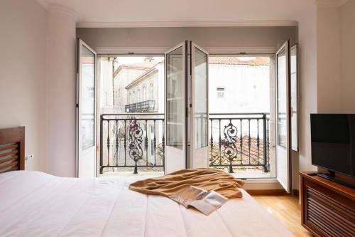 a bedroom with a bed and a large window at La Galeria in Vigo