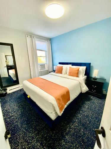 a bedroom with a large bed and a large window at Private Room C West NY, NJ 12 mints from NYCit in West New York