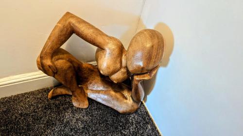a bronze statue of two people forming the letter at The road to Wigan Pier in Pemberton