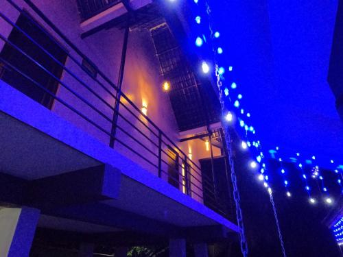 a string of lights on the side of a building at JFZ Homestay in Honāvar