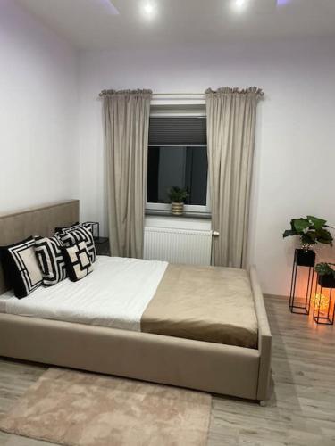 a bedroom with a large bed and a window at Villa Stella Strandnah in Gryfice