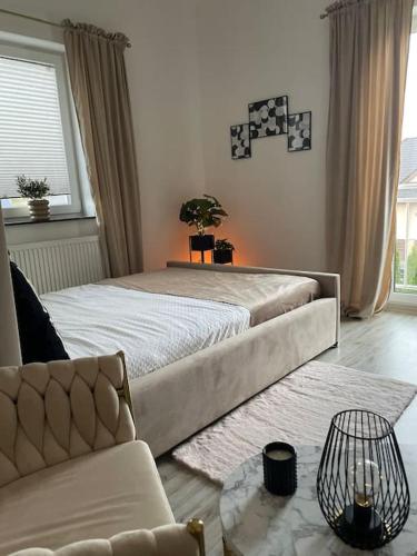 a bedroom with a large bed and a couch at Villa Stella Strandnah in Gryfice