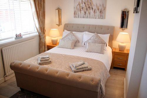 a bedroom with a bed with two towels on it at Beach house in Newcastle upon Tyne