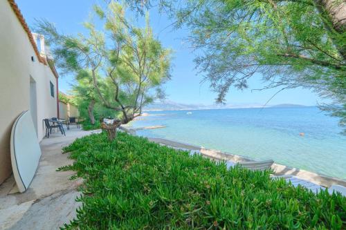 a view of the ocean from a house at Beachfront villa Mihovil with direct beach access in Kastel Stafilic