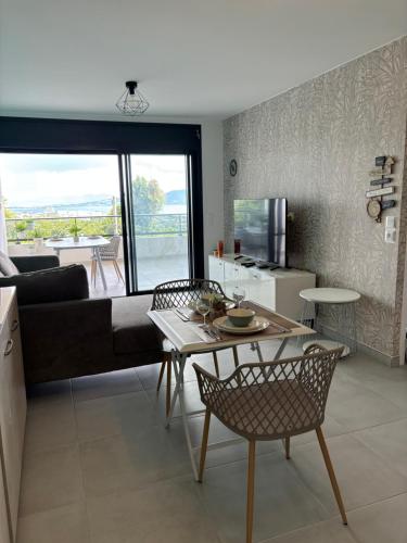 a living room with a couch and a table at Very nice view of the caribbean sea in Schœlcher