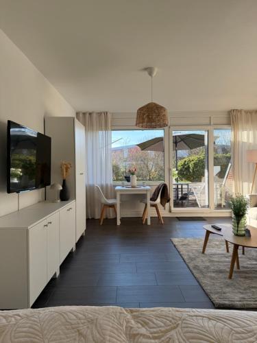 TV a/nebo společenská místnost v ubytování Ferienwohnung Lüttje Mööv an der Nordsee
