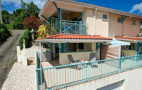 a view of a house with a balcony at Les marches de Paulina in Sainte-Luce