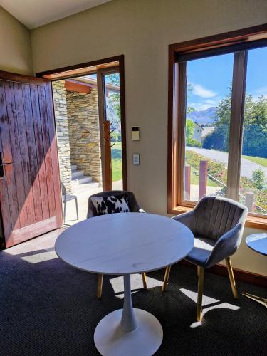 a living room with a table and two chairs at Studio Nestled in Ridgecrest in Wanaka