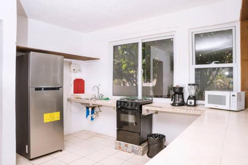 a kitchen with a stainless steel refrigerator and a stove at Monterico- Casa en la playa Pitas2 in El Garitón