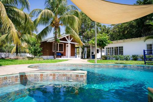 a swimming pool in front of a house at Monterico- Casa en la playa Pitas2 in El Garitón