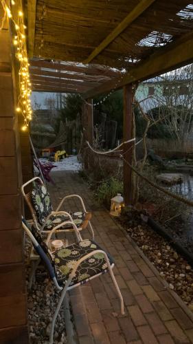 a pair of chairs sitting on a patio with lights at Strandlust Döbeln - Bungalow für eine gemütliche Auszeit im Herbst in Döbeln