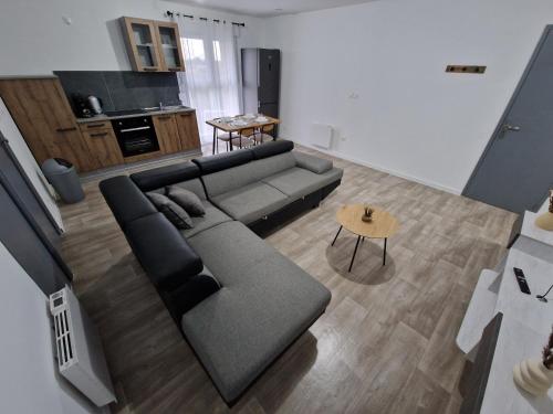 a living room with a couch and a table at AU BON PLAN in Maubeuge