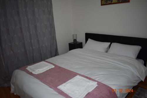 a bedroom with a bed with two towels on it at Anatoli's house in Kastoria