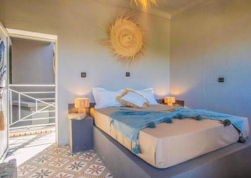 a bedroom with a large bed in a room at Nomad in Marrakech