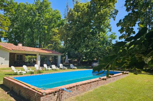 a swimming pool in the backyard of a house at LA CASONA BROWN in Chacras de Coria