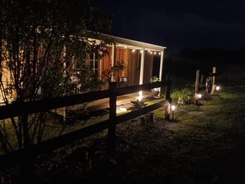 a small cabin with lights in the dark at Country Cottage Sunshine Coast in Montville