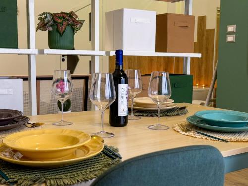 a table with glasses and a bottle of wine at La dimora di isabel in Molfetta