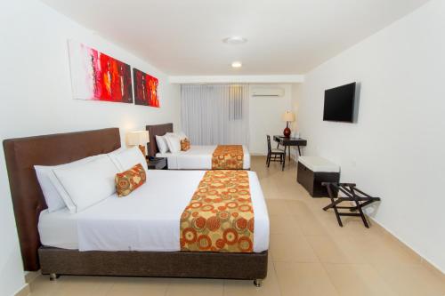 Postel nebo postele na pokoji v ubytování Hotel Playa Club