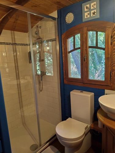a bathroom with a toilet and a sink at Les roulottes Vesta in Léognan
