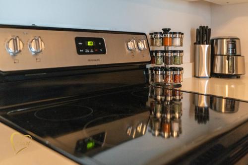 a stove top oven in a kitchen with spices at Lumiére Penthouse in Miami