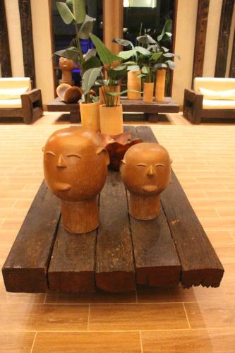 a wooden table with three heads on top of it at Refeições inclusa - Polinesia Resort - Porto de Galinhas - Apartamentos com somente 1 opção de Térreo com Piscina Privativa - Acesso ao Hotel Samoa in Porto De Galinhas