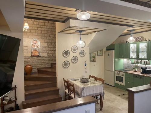 a kitchen with a table and some plates on the wall at Petrini Armonia, Vitsa Zagori in Vitsa