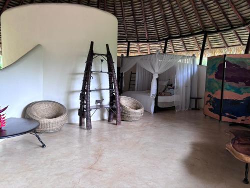 a room with a tent with a table and baskets at Las Nubes Natural Energy Resort in Savegre