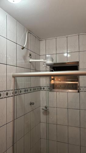 a shower with a glass door in a bathroom at Casa familiar com 2 quartos 2 banheiros perto de Sao Bernardo do Campo in São Bernardo do Campo