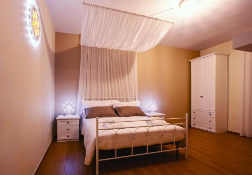 a bedroom with a bed with a canopy and two night stands at Alle Luminarie in Bari