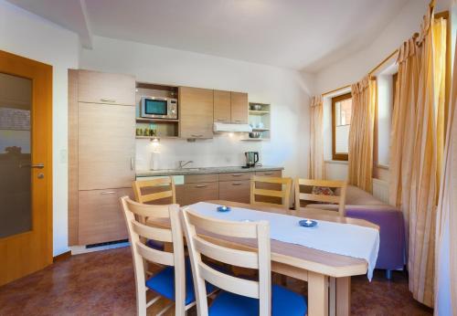 a kitchen and dining room with a table and chairs at Amtshaus in Tux