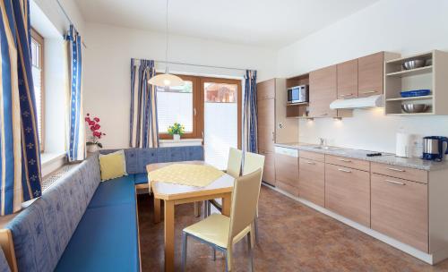 a kitchen with a table and chairs in a room at Amtshaus in Tux