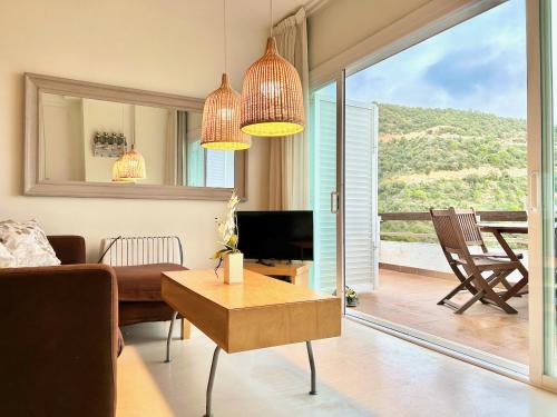 a living room with a couch and a table at Luxury Duplex - 2 Terraces - Private Beach in Tossa de Mar