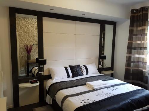 a bedroom with a bed with a large headboard at Voyage Deluxe Master Room in La Spezia