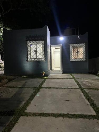 a blue house with a white door and two windows at Casa Aurora in Pisté