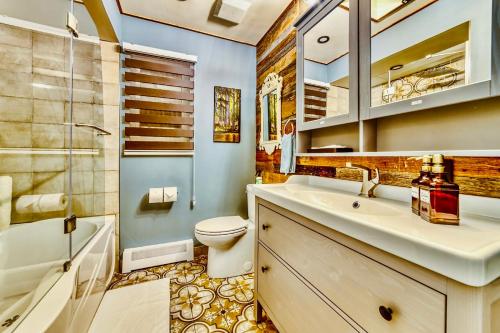 a bathroom with a sink and a toilet and a shower at Neocolonial Nouveau Kensington Vacation Home in Vancouver