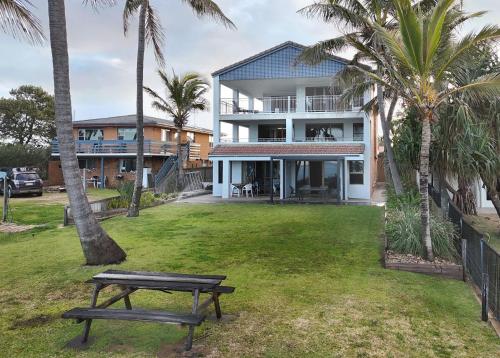 a house with a picnic table in the yard at Horizons 1 in Bargara